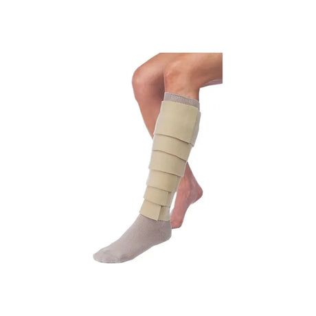 Leg in adjustable beige compression wrap and gray sock, medical support for swelling relief.