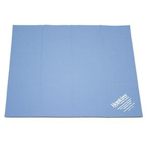 Blue medical supply underpad with white Hopkins label on corner, used for patient care
