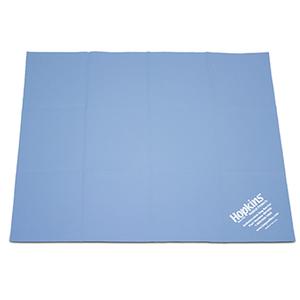 Blue medical supply underpad with white Hopkins label on corner, used for patient care