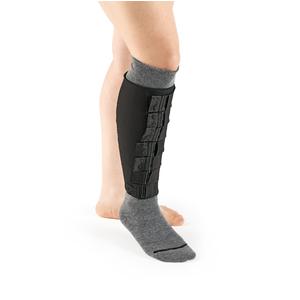 Lower leg wearing a black medical calf brace over a gray sock for support and compression