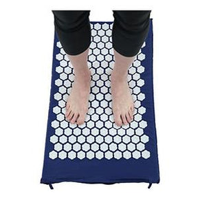 Person standing on acupressure mat for foot therapy and pain relief