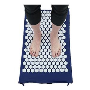 Person standing on acupressure mat for foot therapy and pain relief