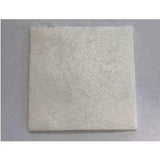 Square white medical gauze pad on a plain background