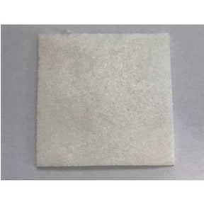 Square white medical gauze pad on a plain background