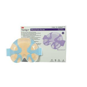Silicone foam border dressing with adhesive wings in front of product packaging
