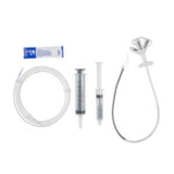 Feeding tube kit with two syringes, tubing, and medical lubricant on a white background