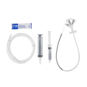 Feeding tube kit with two syringes, tubing, and medical lubricant on a white background
