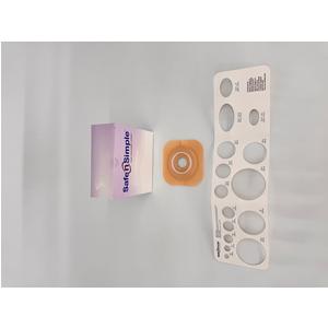 Ostomy barrier ring, stoma measuring guide, and product box on light background