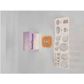 Ostomy barrier ring, stoma measuring guide, and product box on light background