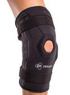 Adjustable black knee brace with open patella support worn on leg, orthopedic medical supply