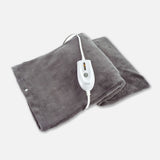 Gray electric heating pad with white digital controller on soft fabric background