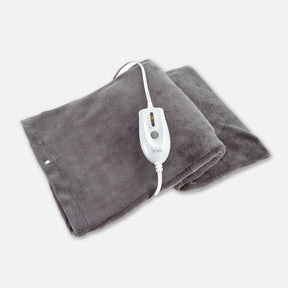 Gray electric heating pad with white digital controller on soft fabric background