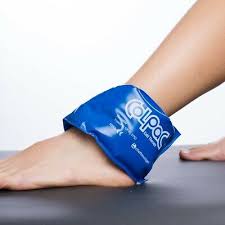 Blue cold therapy gel pack wrapped around an ankle on a white background