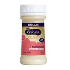 Enfamil Premature infant formula bottle with beige liquid and pink label on white background.