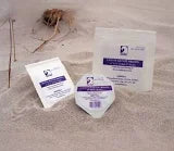 Sterile medical supply packets arranged on sand for home healthcare delivery