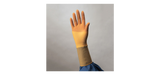 Hand wearing a beige medical compression glove, shown against a neutral background
