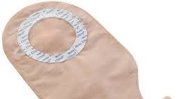 Beige medical ostomy bag with adhesive ring for stoma care and chronic condition support