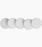Five round white cotton pads for medical or personal care on a plain background