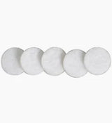 Five round white cotton pads for medical or personal care on a plain background