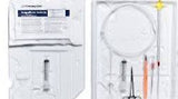 Medical catheter insertion kit with syringe, gloves, tubing, and sterile tools in tray