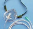 Oxygen mask with tubing for respiratory support on blue background
