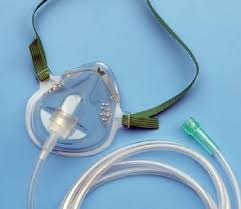 Oxygen mask with tubing for respiratory support on blue background