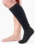 Person wearing black compression sock for leg support, medical supplies product