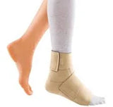 Beige ankle support brace on foot for injury recovery or compression