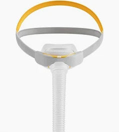 Nasal CPAP mask with headgear and air tube for sleep apnea therapy on white background
