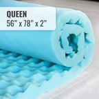 Rolled blue queen-size egg crate foam mattress topper, 56 x 78 x 2 inches, on a bed.