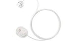 Medical infusion set with clear tubing and white adhesive patch on a white background