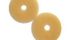 Two round beige ostomy barrier rings for medical supply and chronic care support
