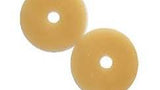 Two round beige ostomy barrier rings for medical supply and chronic care support