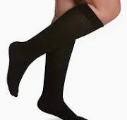 person wearing black knee-high compression socks for medical support