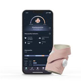 Wearable sleep tracker device beside smartphone displaying sleep monitoring app dashboard