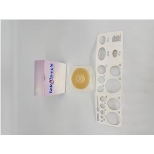 Ostomy barrier ring with sample box and stoma measuring guide on white background