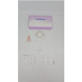 Ostomy care kit with barrier ring, stoma measuring guide, and medical supplies on white background