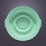 Green silicone breast pump seal with concentric ring design on a neutral background