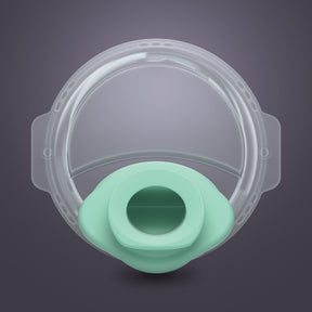 Clear silicone breast pump spout and valve with mint green center on gray background