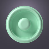 Top view of a green silicone breast pump diaphragm against a gray background