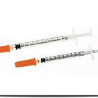 Two sterile insulin syringes with orange caps for medical injection use