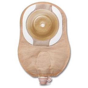 Beige medical ostomy bag with adhesive and drainage spout on white background