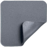 Square gray medical adhesive foam bandage with one corner peeled back