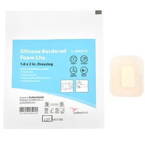 Silicone bordered foam dressing 1.6 x 2 in with packaging and pad for wound care