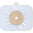 Adhesive ostomy barrier with center opening for medical supply, white and beige, on white background