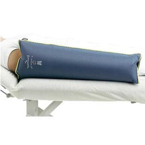 Leg positioned on blue medical leg support cushion on a bed, used for injury recovery