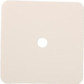 Square beige adhesive medical patch with central hole on white background