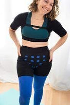 Woman wearing adaptive compression support garment for chronic condition at home
