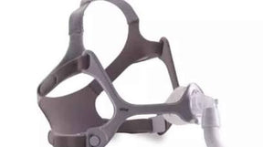 CPAP nasal mask with headgear for sleep apnea therapy on white background