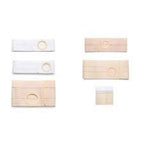 Assorted beige and white adhesive medical dressings with central openings, isolated on white background.